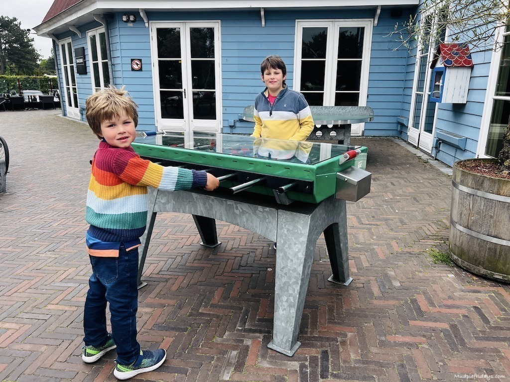 The boys playing free table football outside the Duinrell plaza