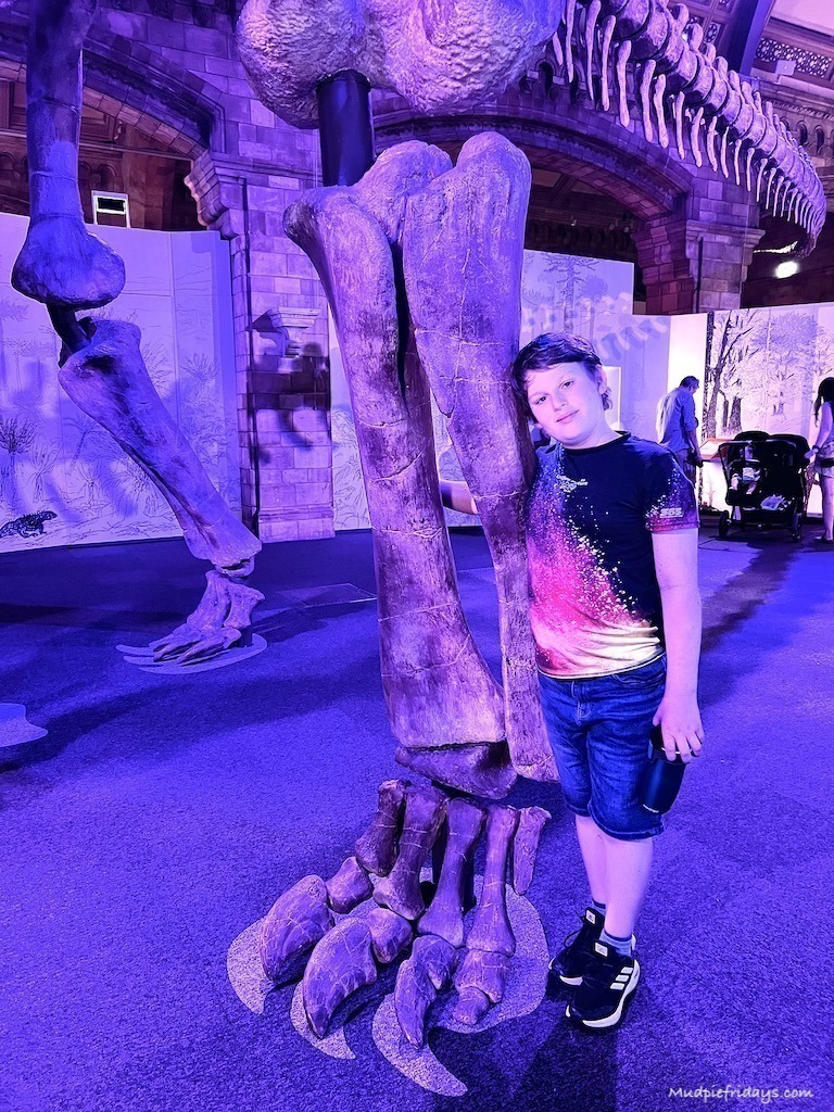 Charlie standing next to the cast of the titanosaur