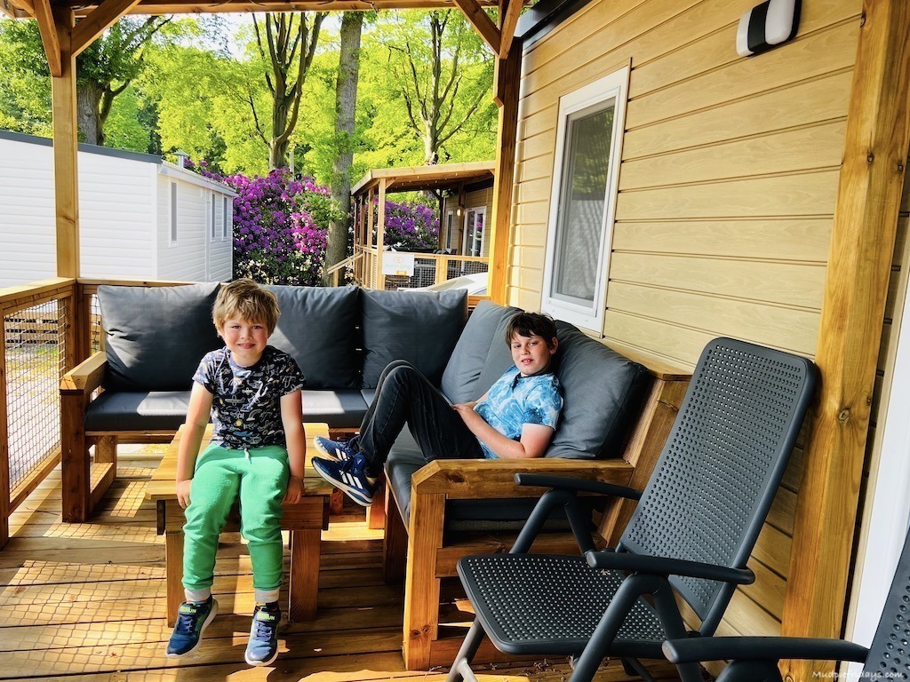 The boys sitting on the new sofa in the Eurocamp Duinrell Azure Lounge - 3 bedroom