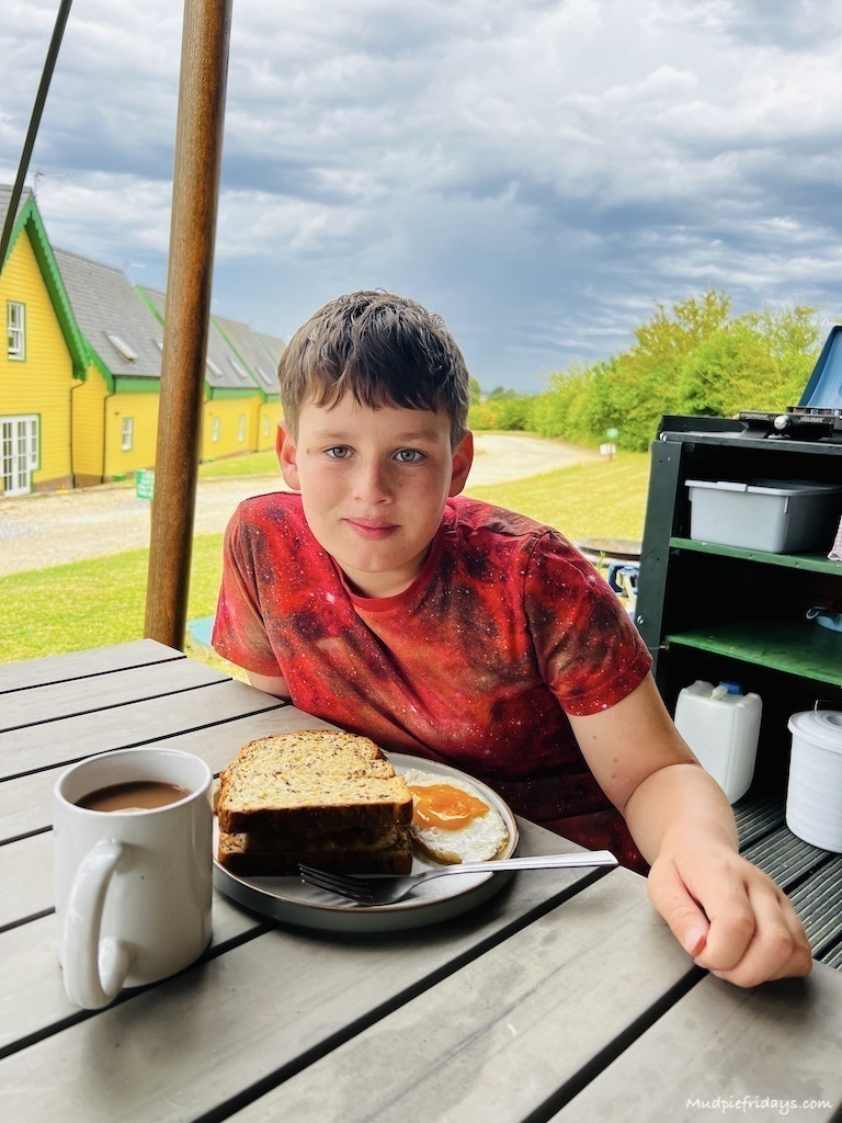 Charlie eating breakfast in the fresh air outside the safari tent