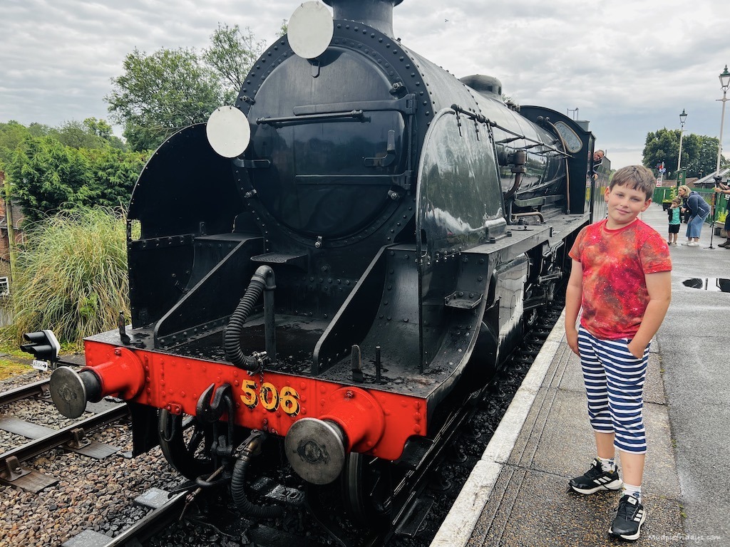 Charlie standing in front of a steam train in Hampshire