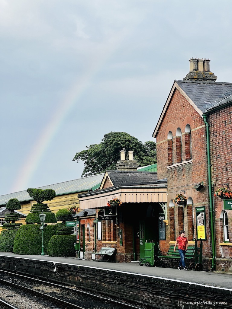 Ropley train station with a rainbow in the background
