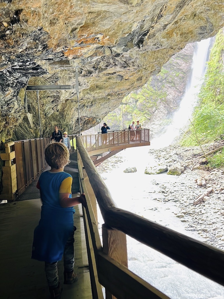 Harry walking along the walkway to approach the large waterfall