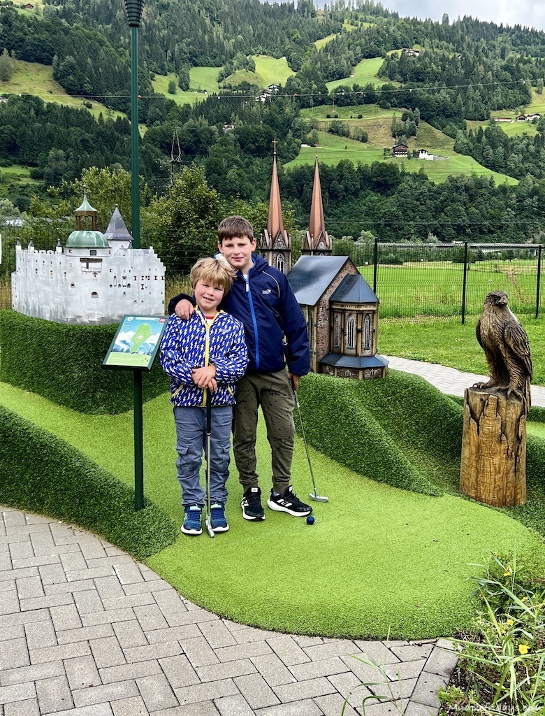 The boys posing in front of some of the attractions that are covered by the minigolf Salzburg