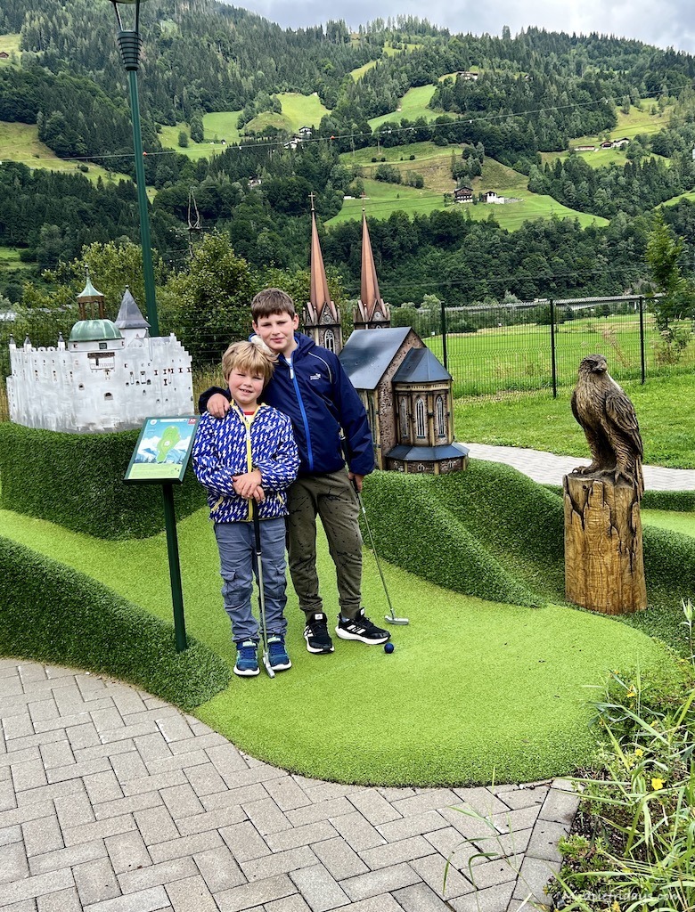 The boys standing next to some of the golf holes in the JO adventure minigolf