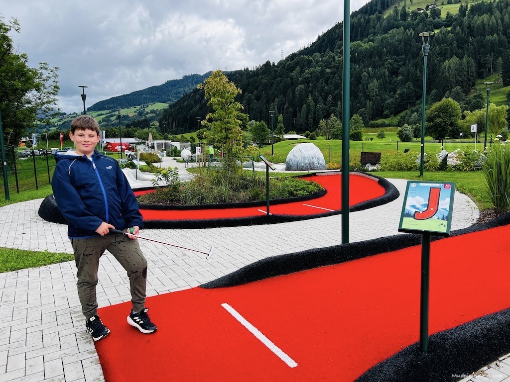 Charlie posing by a red JO on the minigolf course
