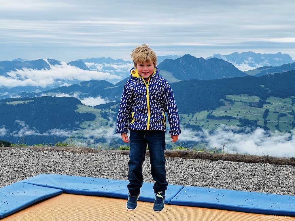 Harry jumping on a trampoline at the top of the top of Spielijoch Mountain which we reached with our Summer Zillertal Activcard