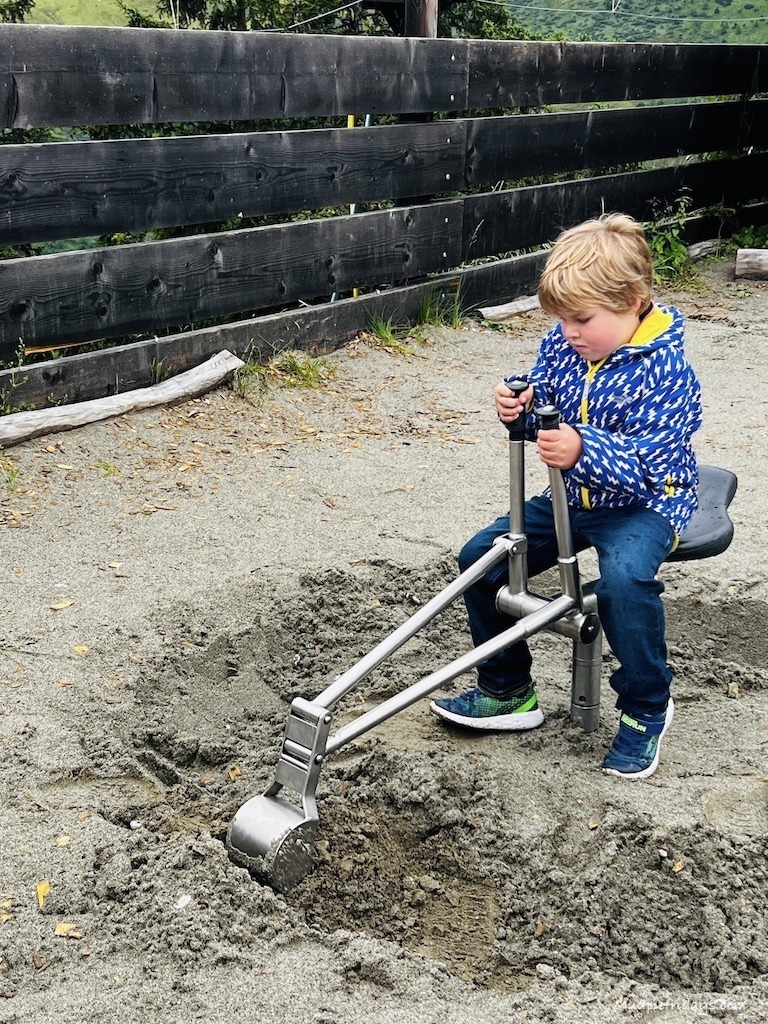 Harry playing with a sit on dinner in one of the adventure playgrounds