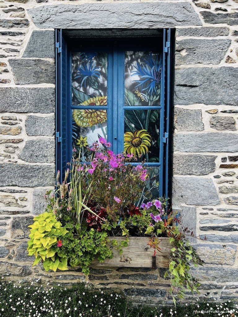 Cute Brenton stone buildings along narrow streets covered in flowers