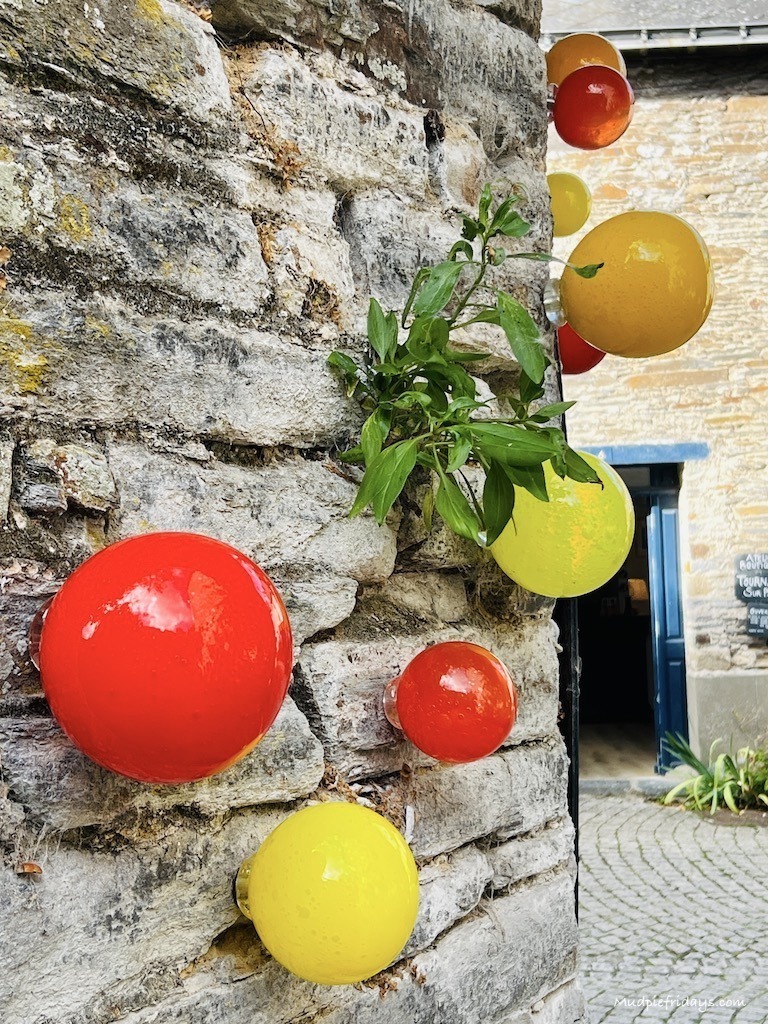 blown glass on the side of one of the craft shops in La Gacilly