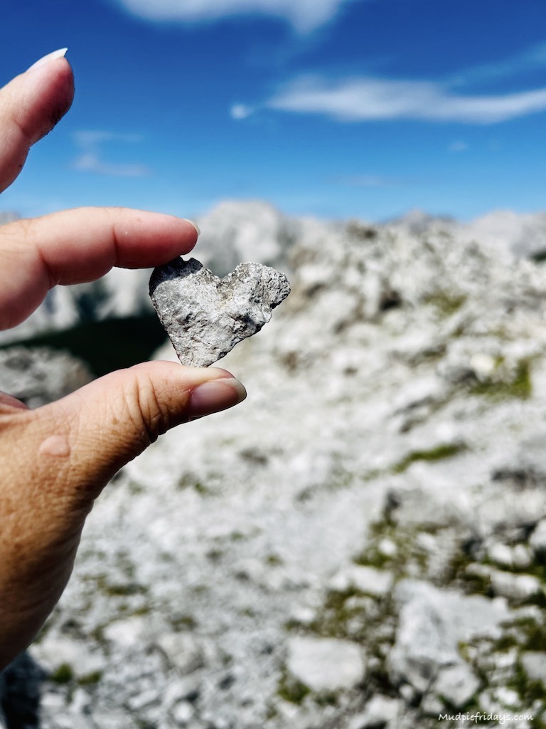 Finding a heart shaped stone at the top of Innsbruck in the mountains