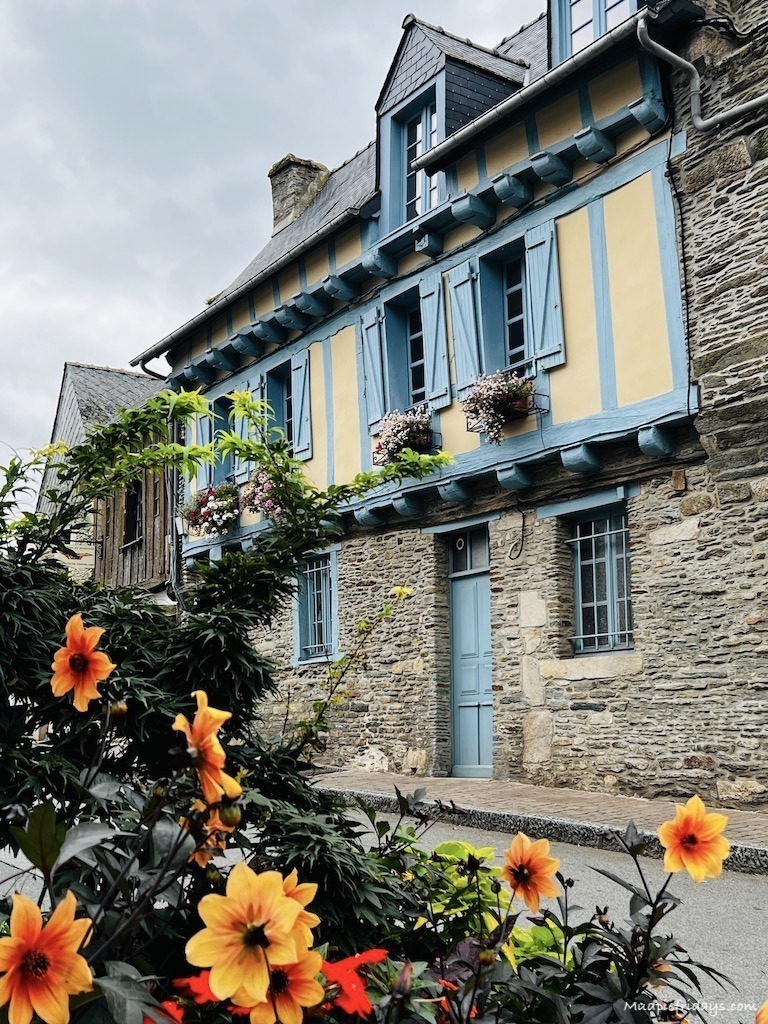 Half-timbered house in Josselin with brightly coloured flowers in front