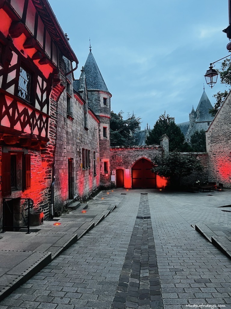The back of the chateau all lit up in red in the evenings