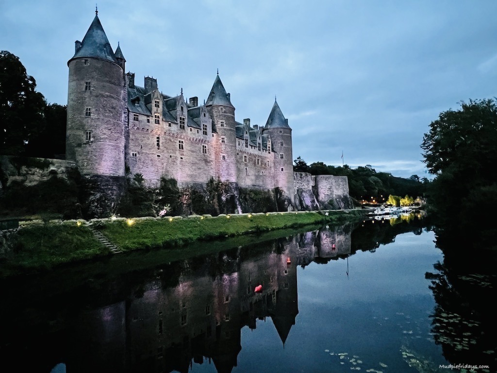 Reflection of Josselin Chateau in the river all lit up at night