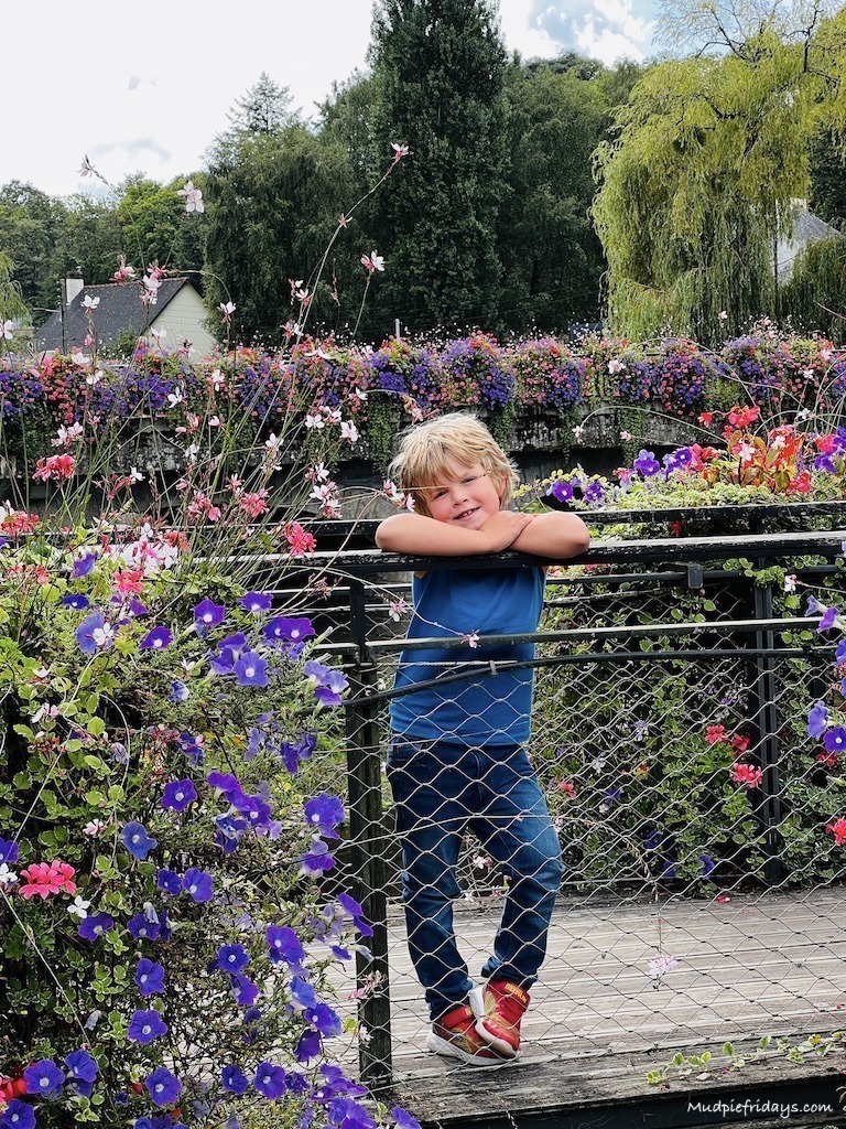 Harry standing on a flowery bridge