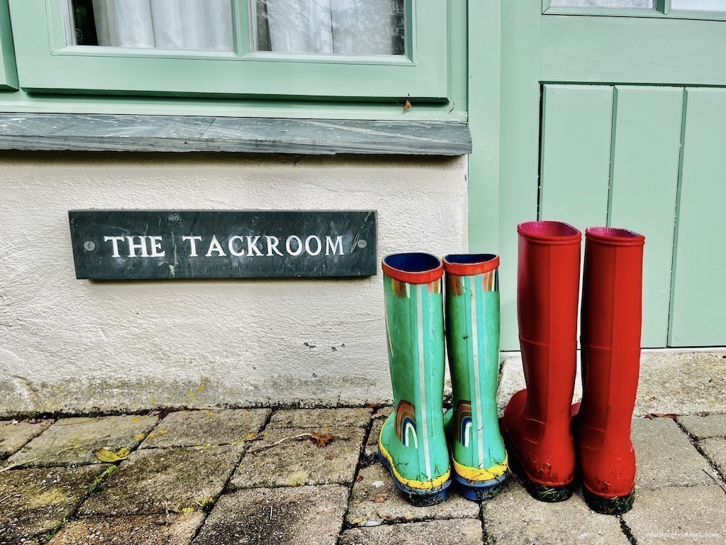 The boy's wellies outside the tack room cottage sign