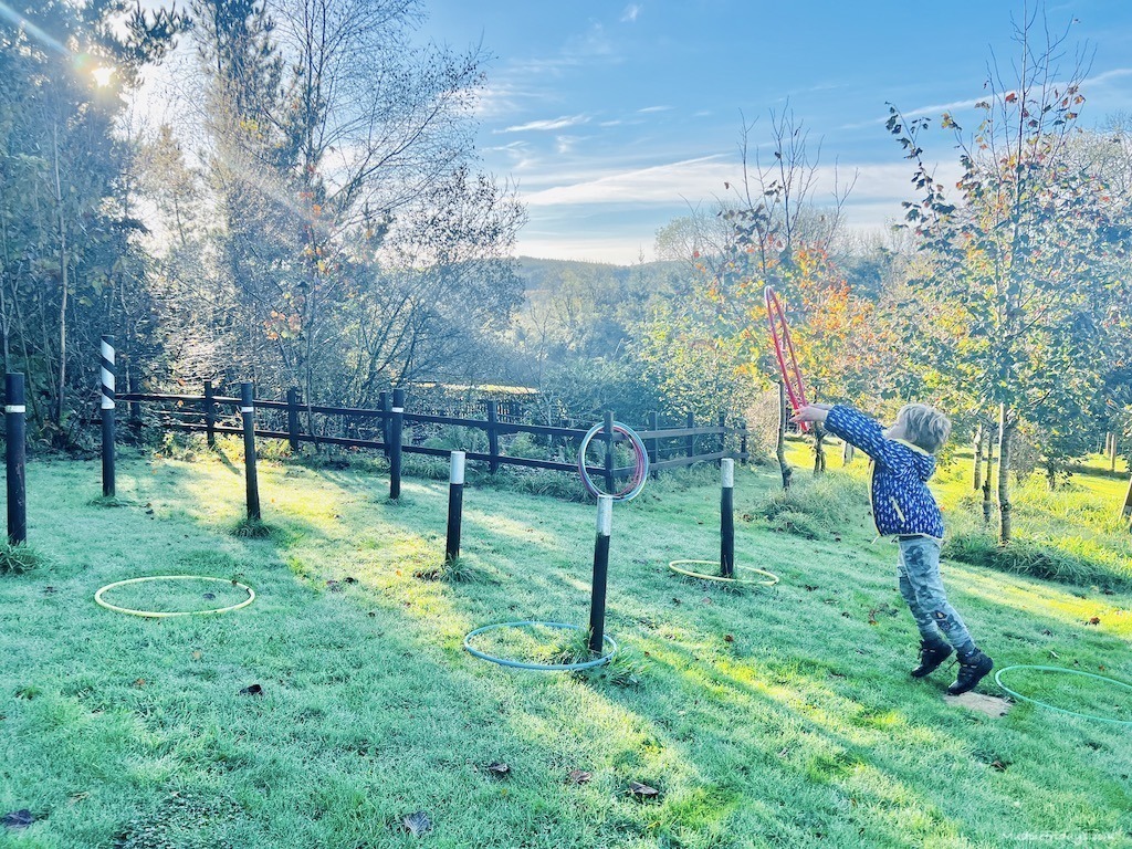 Harry throwing hoops over some posts at our farm stay in Cornwall