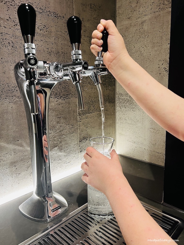Charlie pouring water from the water station which is on every floor in the hotel