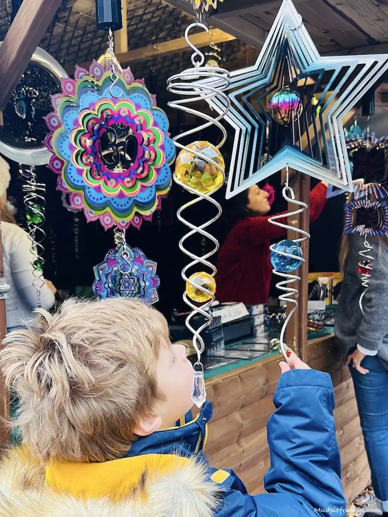 Harry looking at spinning things at the Christmas market in London