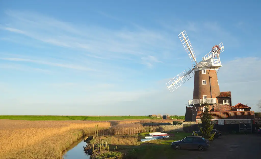 Cley windmill at sunrise with a wheat field in the background