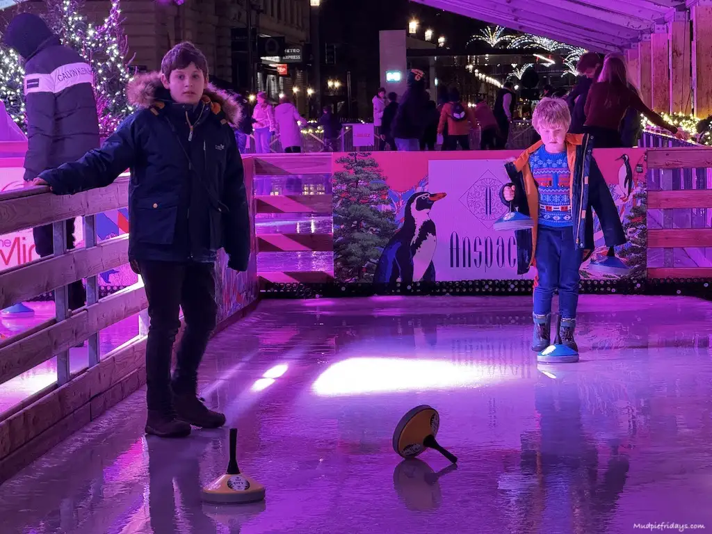 Harry holding a curling stone when we played on the ice