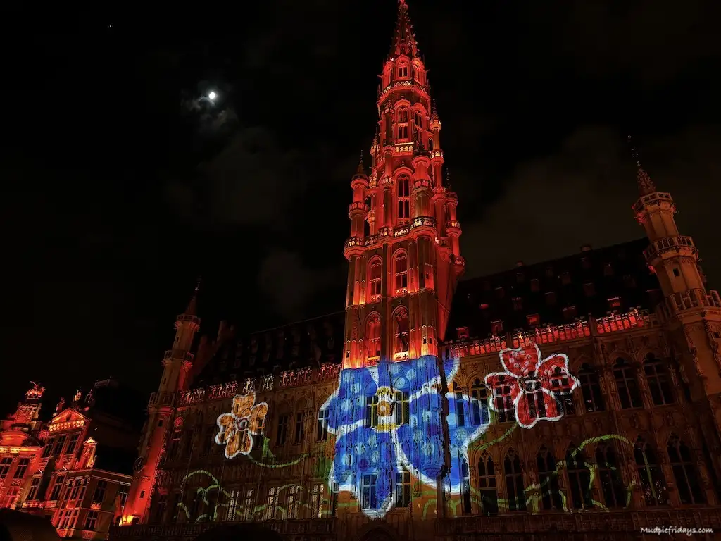 The grand place all lit up by a light show at Christmas