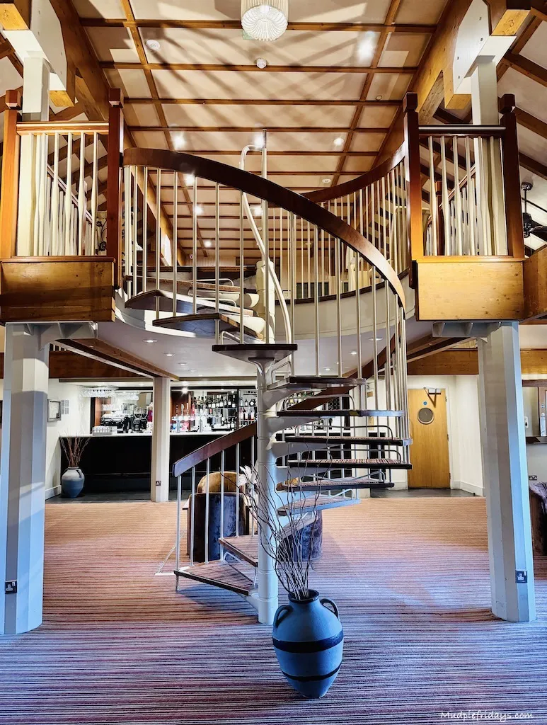 The spiral staircase leading up to the mezzanine seating area in the bar