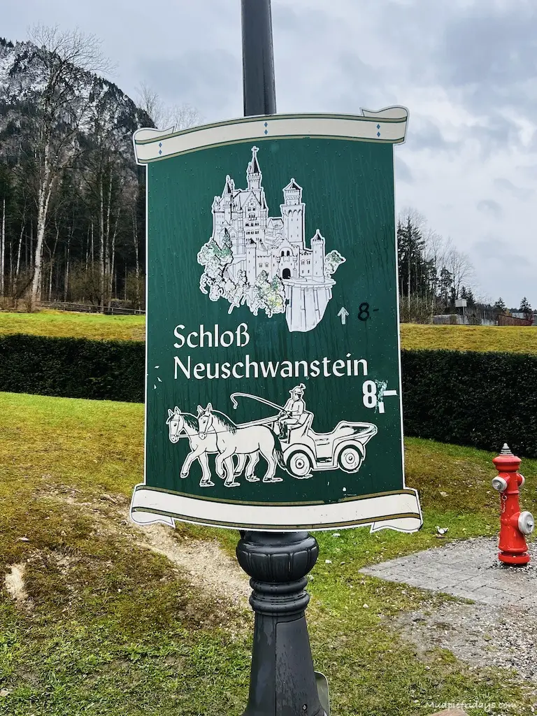 neuschwanstein castle tips - the sign that shows where to stand to get the horse and trap up to the top of the hill