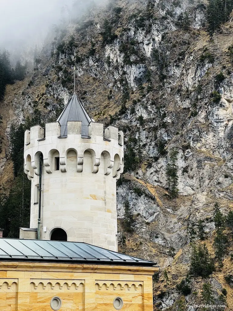 One of the turrets on the castle with the mountain in the background