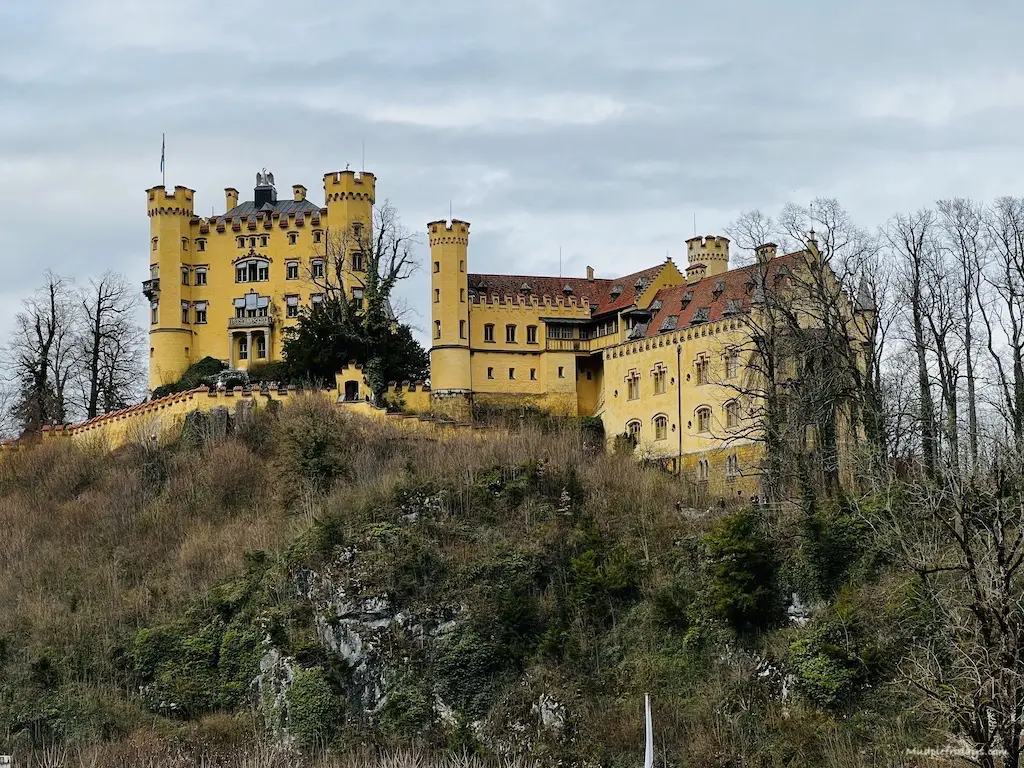 Hohenschwangau Castle painted in yellow looking up from the bottom