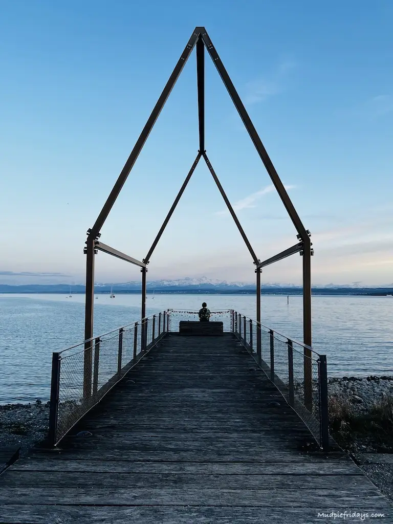 Charlie looking out across the bodensee in a wooden house structure that we found while exploring UnterUhldingen - lake constance bodensee