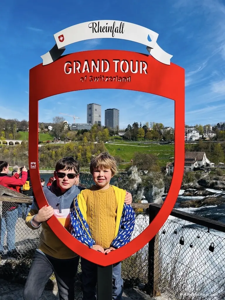 The boys standing inside the Swiss Grand Tour sign