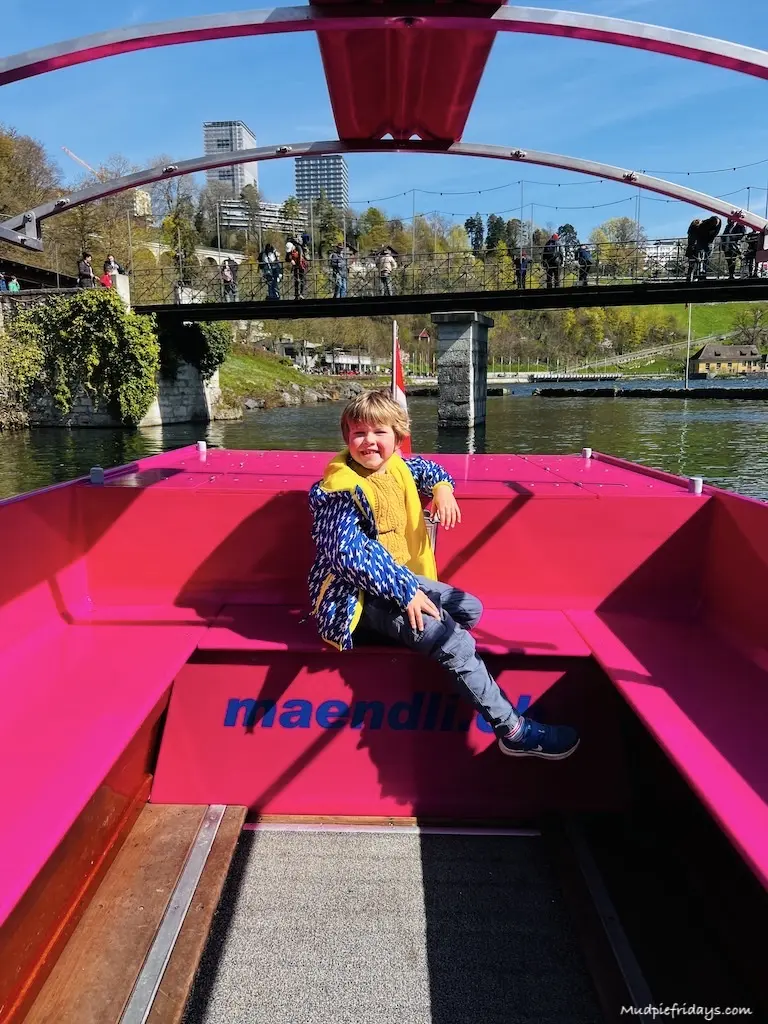 Harry sitting on a pink boat ready for his boat trip