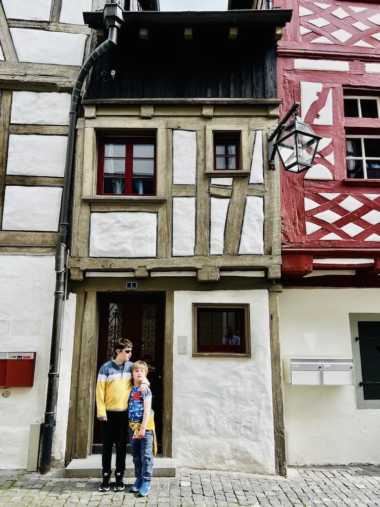 The boys in front of one of the half-timbered house when visiting Stein am Rhein in Switzerland