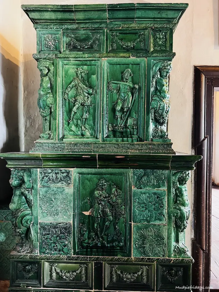 a green ceramic tiled heating unit in Germany
