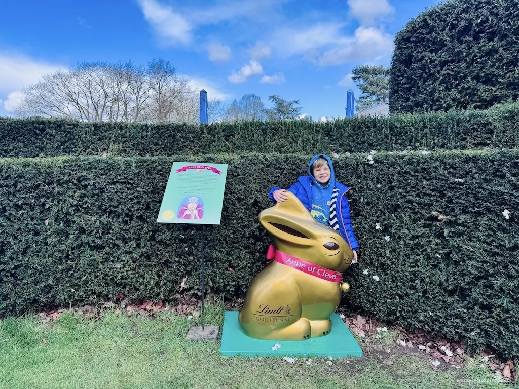 Harry standing in front of one of the twelve gold bunnies