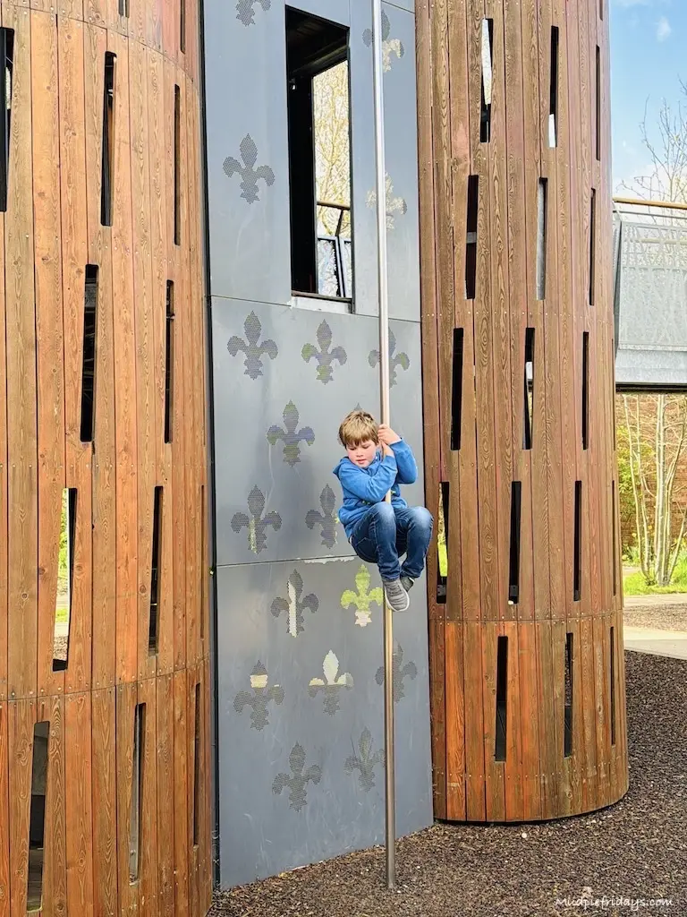 Harry going down the fireman's pole in once of the wooden towers