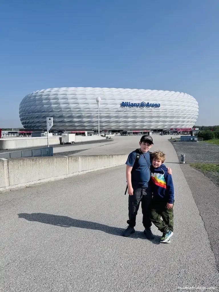 The boys standing outside Bayern Munich Football Club - Allianz Stadium in Munich