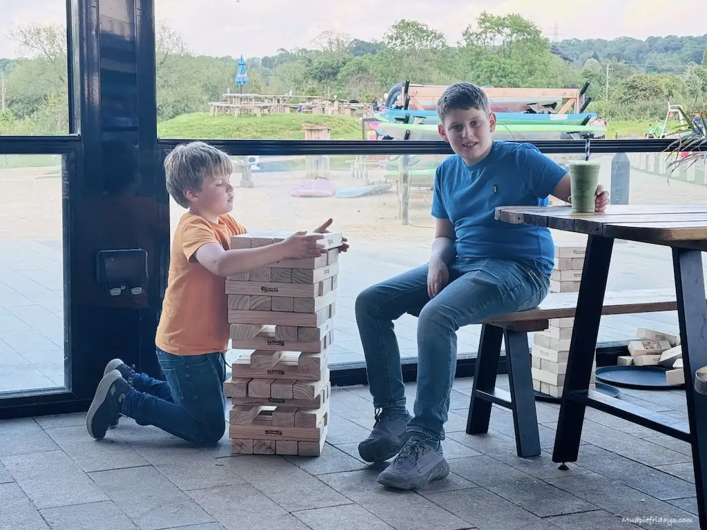 The boys playing Jenga inside the conservatory which is part of the The wave restuarant