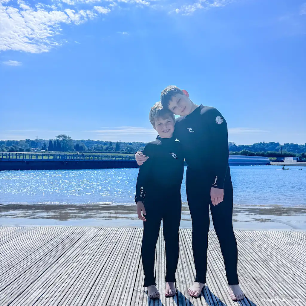 The boys in their rip curl wetsuits waiting for their surf lesson
