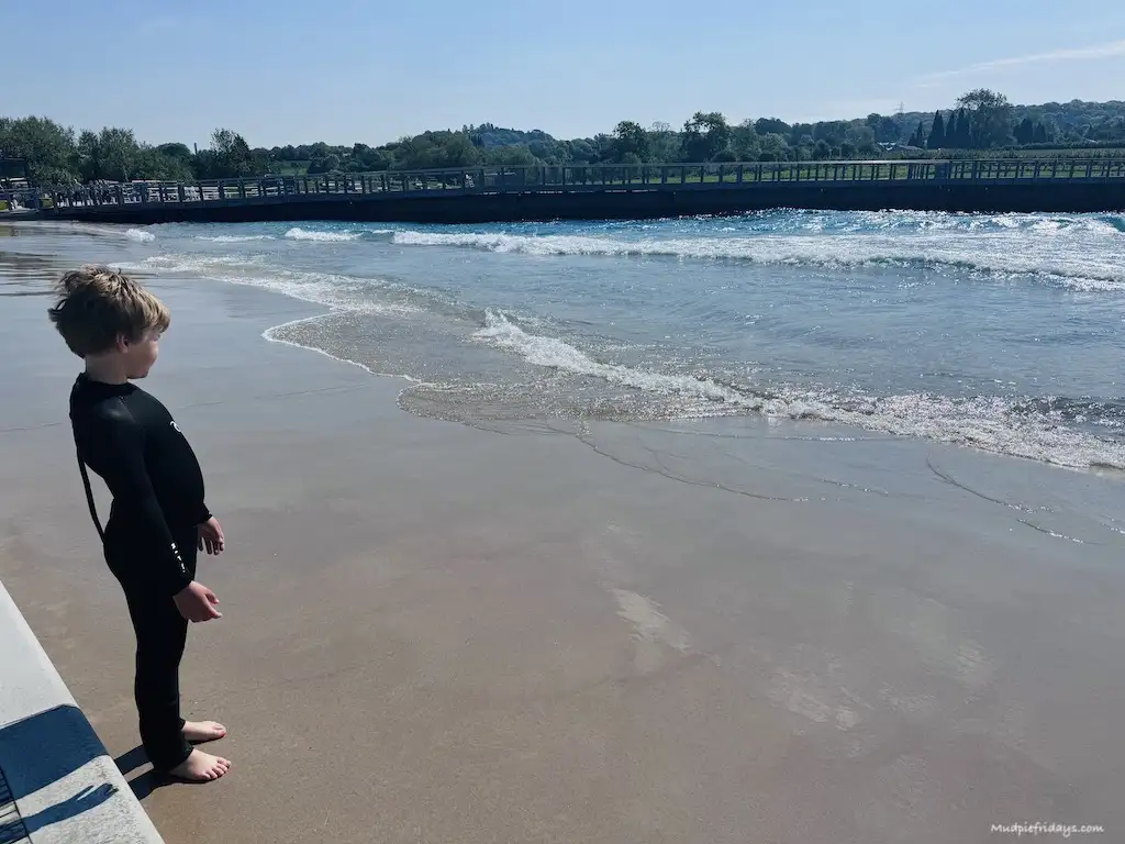 Harry looking out across the lake with the waves breaking on the shore