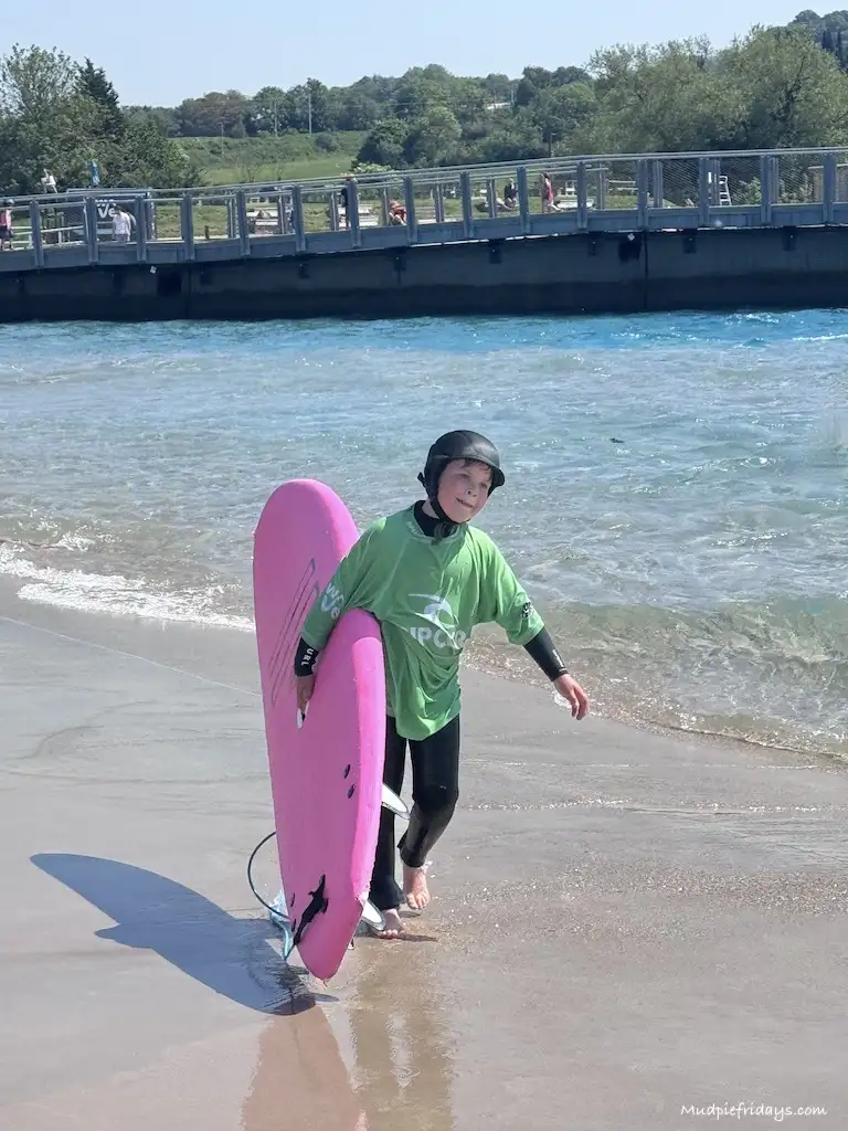 Harry carrying his surf board