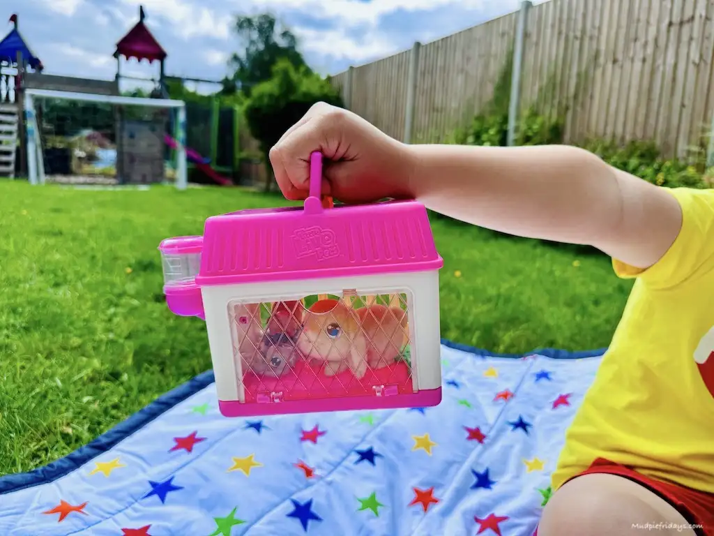 Harry holding the travel cage of the Little Live Pets Mama Surprise Minis - Lil' Bunny