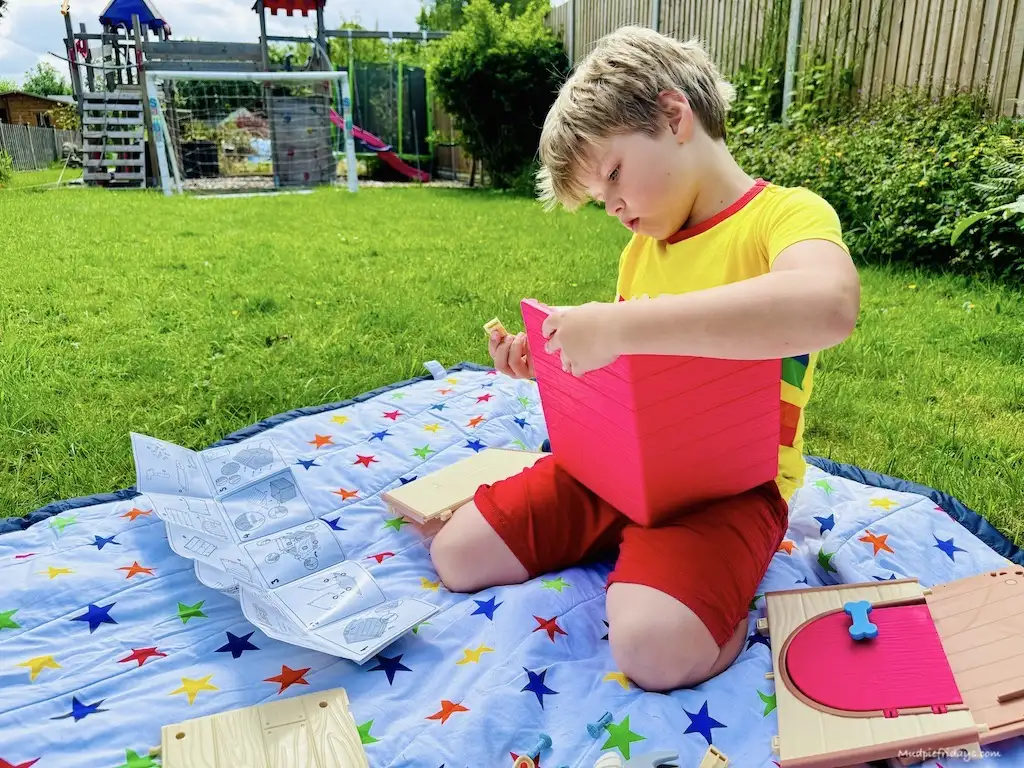 Harry building the little dog house for his new puppy pet