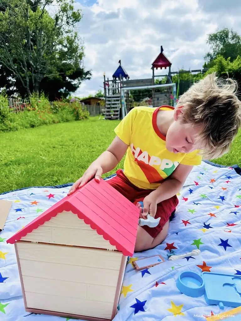 Harry building the little dog house for his new puppy pet
