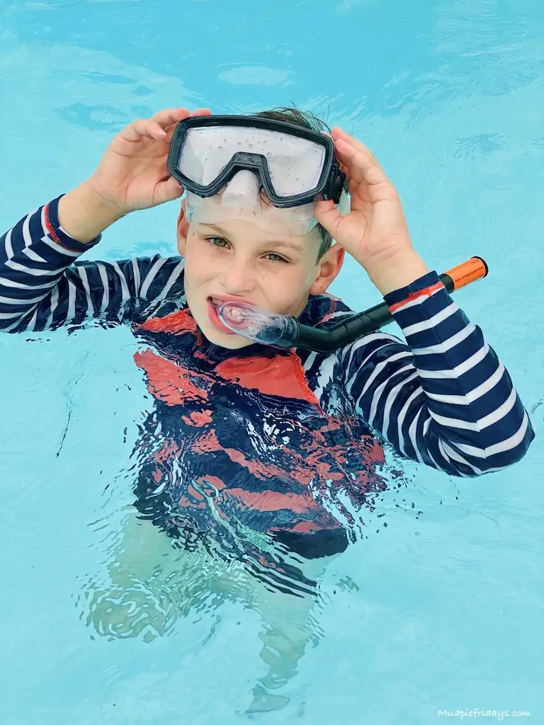 Charlie with a mask and scuba gear playing in the pool Eurocamp holiday packing list