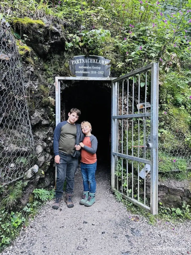 The boys standing under the entrance way to Partnach Gorge / Partnachklamm