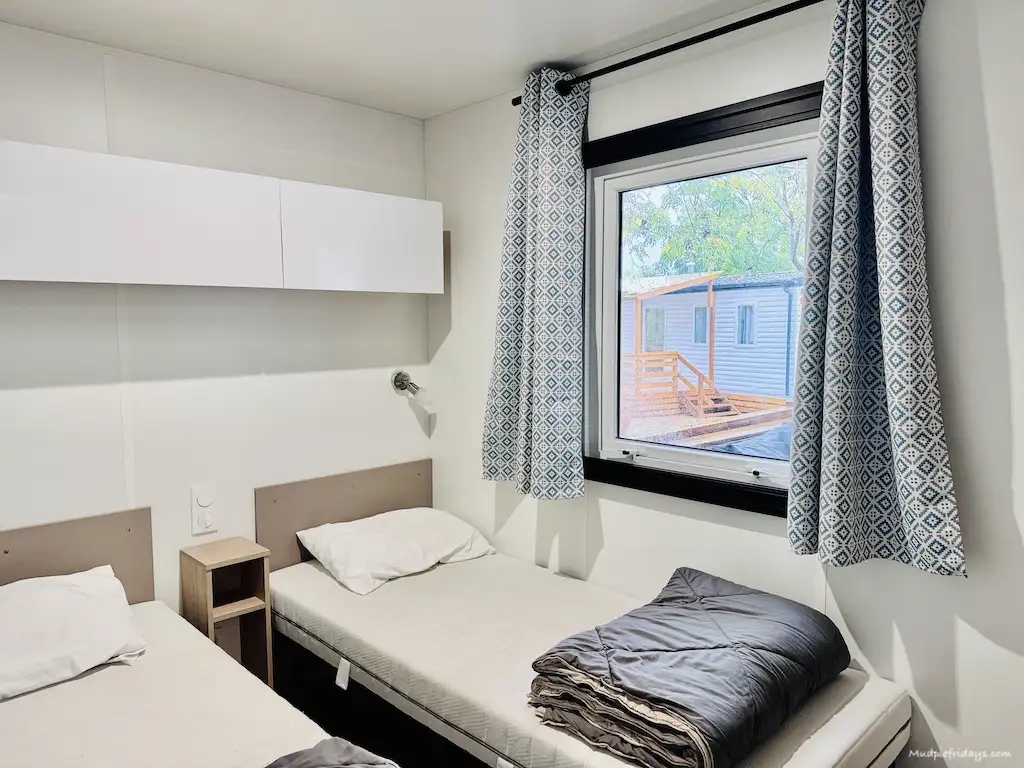 One of the twin rooms in our premium mobile home staying at Vilanova Park with Eurocamp