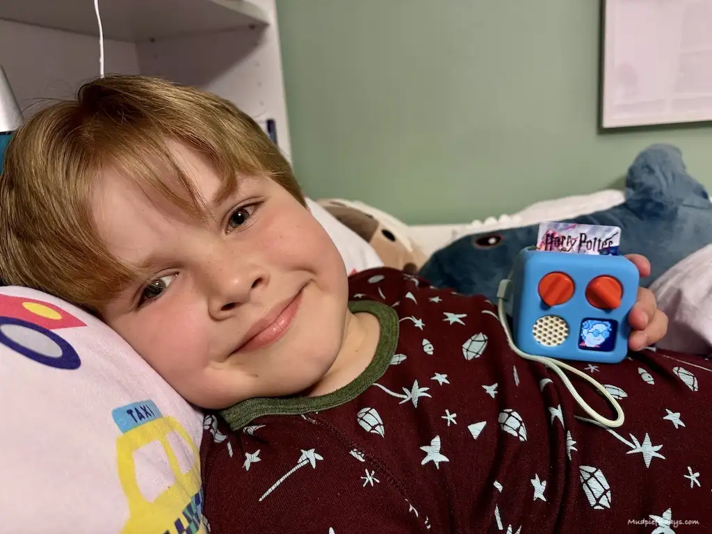Harry with his mini yoto player and a harry potter card 
