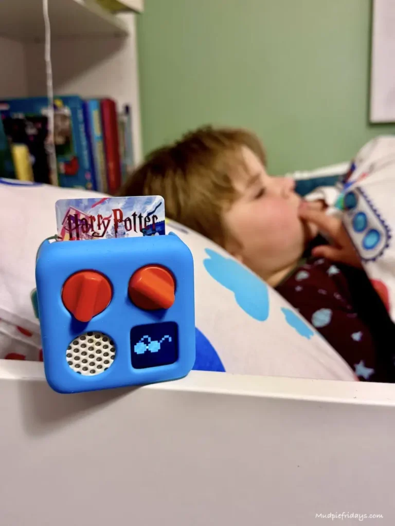 Harry with his mini yoto player and a harry potter card 